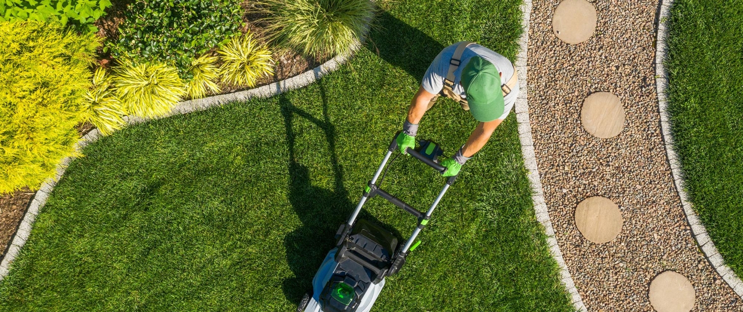 Top down view of a person mowing grass