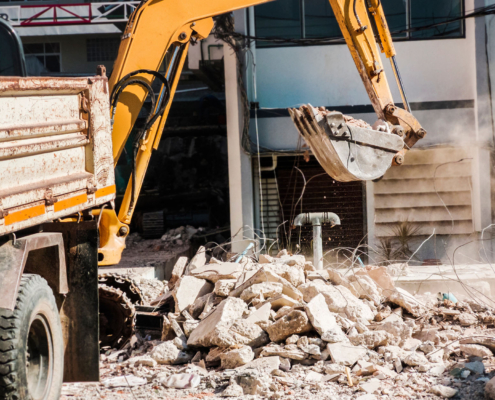 Bulldozer Removes the debris from demolition on the construction site