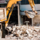 Bulldozer Removes the debris from demolition on the construction site