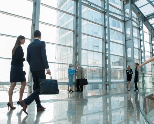 Side view of people walking in office hallway