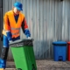 Janitor taking out garbage bins