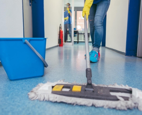 janitor mopping floor of commercial building