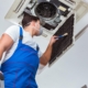 person cleaning vents in office